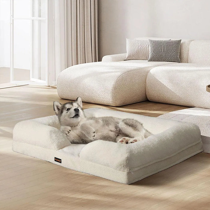 Dog enjoying lying on the white boucle dog bed