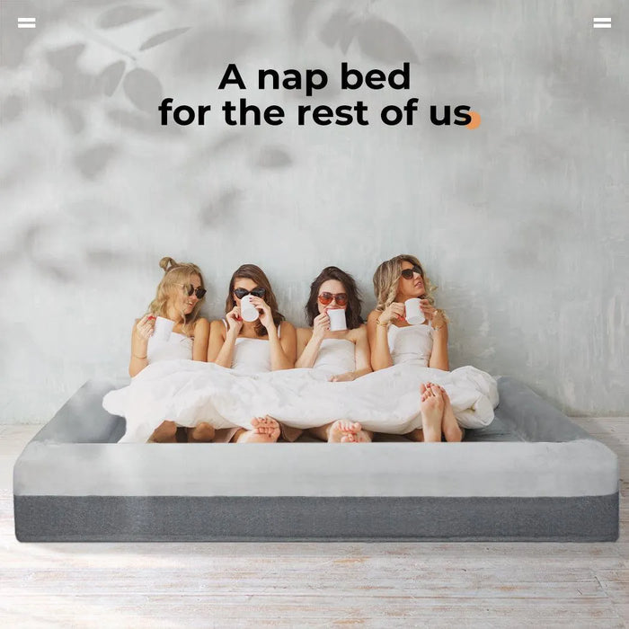 Girls relaxing on giant human sized dog bed​
