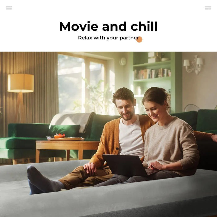 couple sitting on giant human sized dog bed​