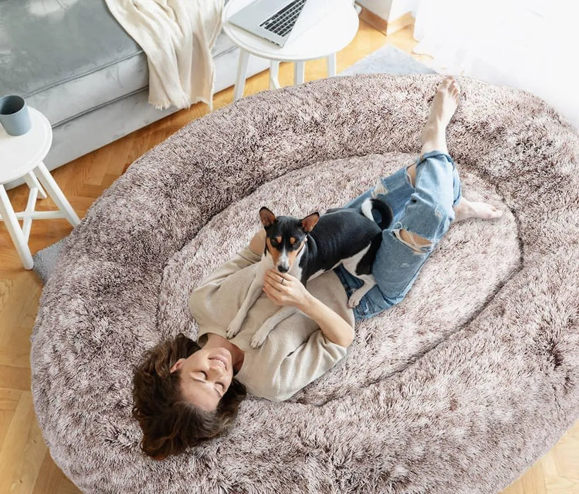 lady with dog relaxing on  The Human Size Nap Bed
