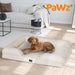 large dog relaxing on white boucle dog bed