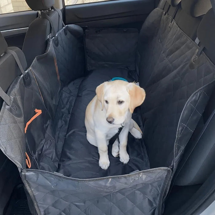 White Puppy on the back seat cover in car